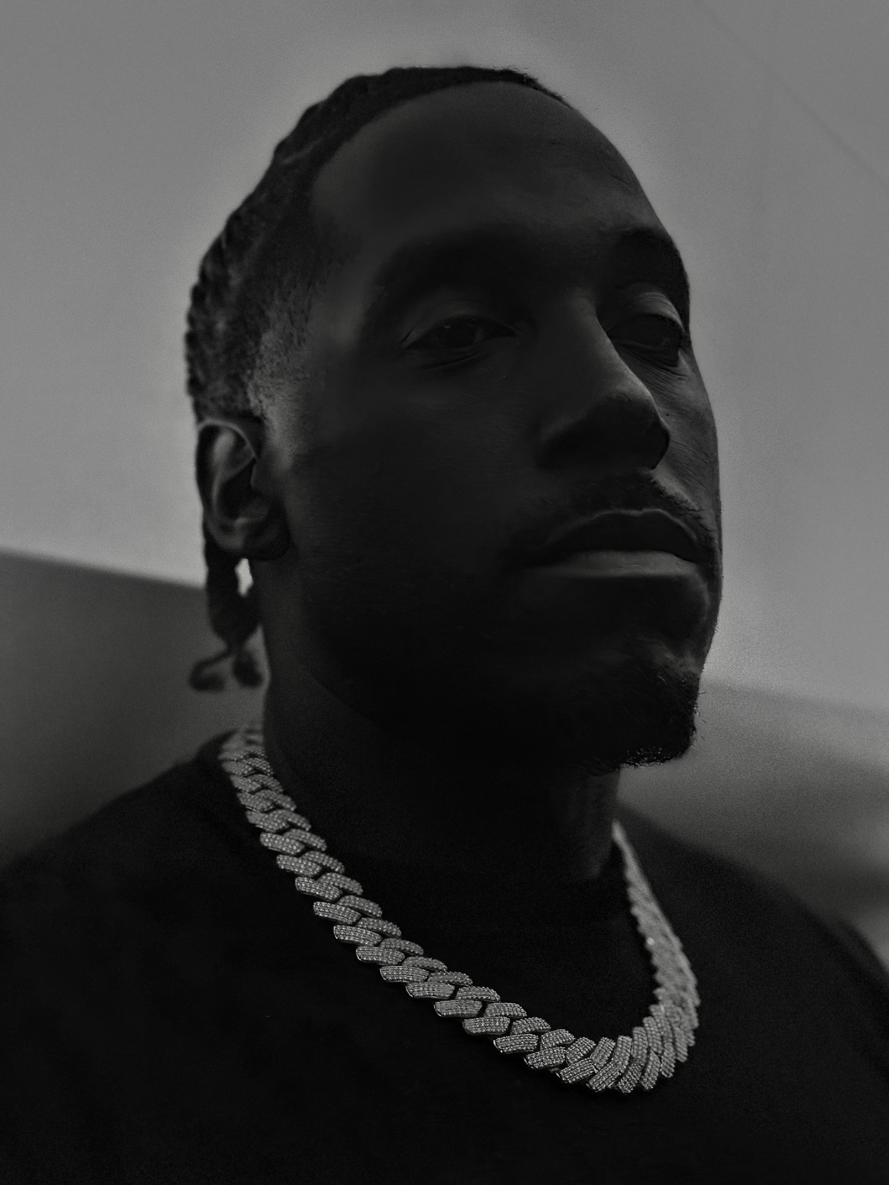 Lee Ali black and white portrait with chain, confidence and vision